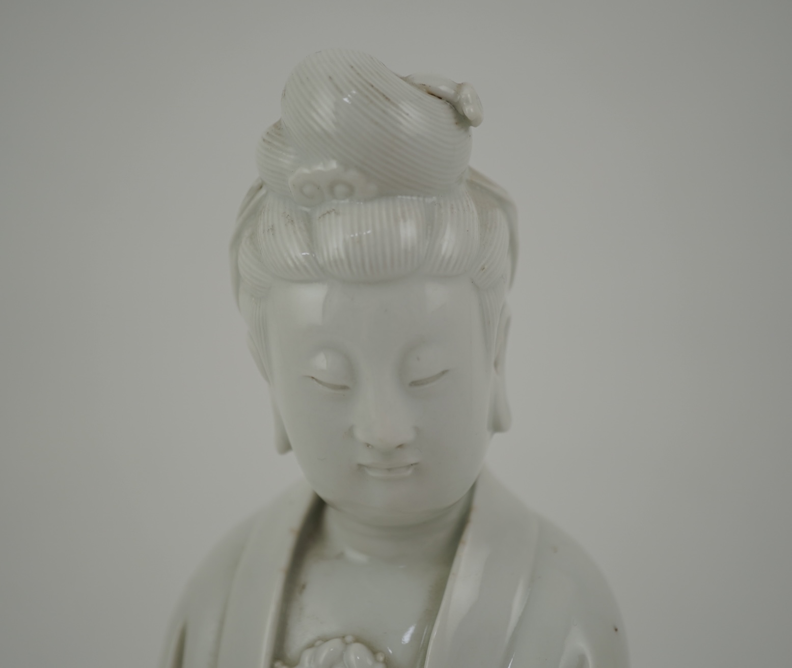 A Chinese blanc-de-chine seated figure of Guanyin, late 19th/early 20th century